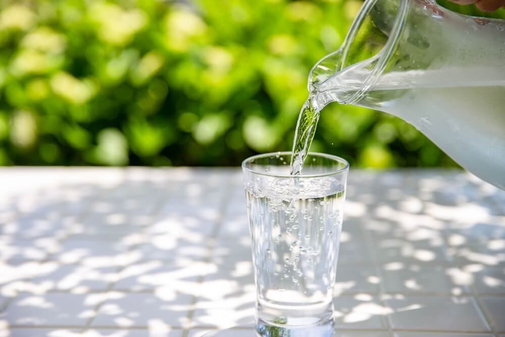 a picture of pouring water into a cup of water